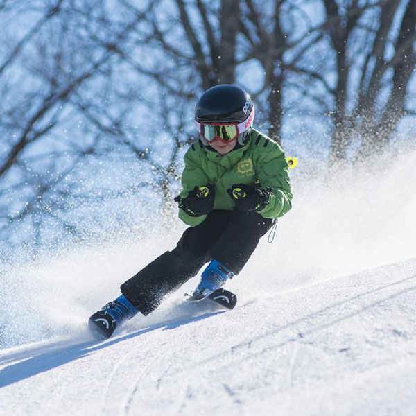 Kid skiing down the hill